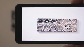 Silent Glyphs AR Painting viewed through a mobile device, displaying augmented reality storytelling elements
